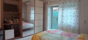 a bedroom with a bed and a large window at Casa Melo in Ciampino