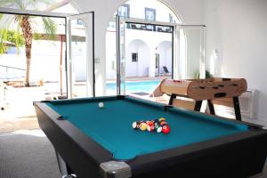 a pool table in a living room with a pool table at SOLAR DOS FRADES in Ferreira do Alentejo