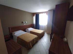 Postel nebo postele na pokoji v ubytování Standard Hotel Udine