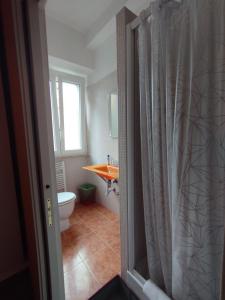 a bathroom with a toilet and a sink at Adriatic Room 50 m dalla stazione Ferroviaria di Ciampino e dalla navetta aeroportuale in Ciampino