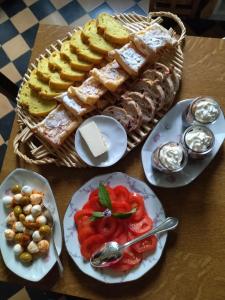 a table with plates of food and a basket of bread at Villa Giselle in Hayange