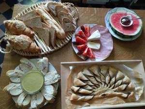 a table topped with different types of bread and pastries at Villa Giselle in Hayange