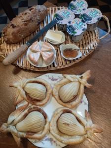 a table with a plate of bread and other foods at Villa Giselle in Hayange