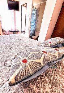 a bedroom with a bed with two pillows on it at Habitacion y Baño Privado in La Serena