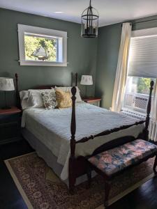 a bedroom with a bed and a window at Rose & Thistle B&B Lunenburg in Lunenburg