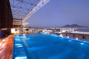 una grande piscina sul tetto di un edificio di ROMEO Napoli a Napoli