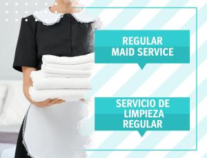 une femme tient une pile de serviettes blanches dans l'établissement OCEANFRONT & Garden View VILLAS HOTEL WIFI BBQ Parking Los Corales beach CLUB & SPA, à Punta Cana