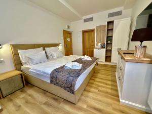 a small bedroom with a bed and a kitchen at Hotel Karlova Prague in Prague