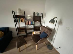 a living room with a chair and a lamp at CityLife InApartment Salzburg in Salzburg