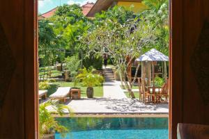 a view of a swimming pool from a house window at The Gong in Uluwatu