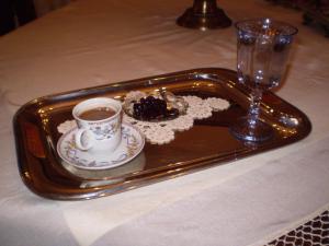 a tray with a cup of coffee and dessert on a table at Chrysoula's Guests in Ioannina