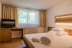 una camera d'albergo con letto e TV di Apartments Tschanun a Gaschurn