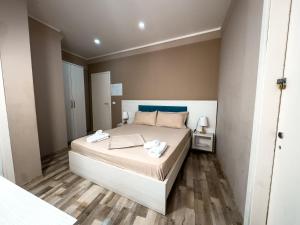 a bedroom with a large bed with a blue headboard at Shkodra Budget Hotel in Shkodër