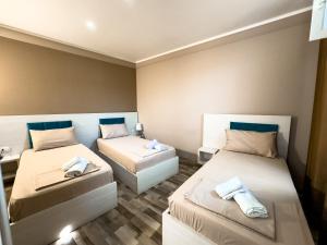 a room with two beds with towels on them at Shkodra Budget Hotel in Shkodër