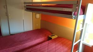 A bed or beds in a room at Premiere Classe Bordeaux Eysines