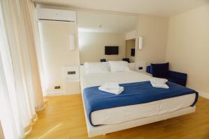 A bed or beds in a room at ORBI CITY King Suite Sea View