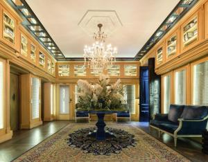 a living room with a chandelier and a table at Only YOU Boutique Hotel Madrid in Madrid