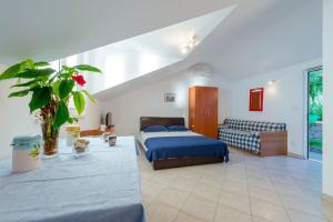 a bedroom with a bed and a couch at Apartments Dia in Dubrovnik