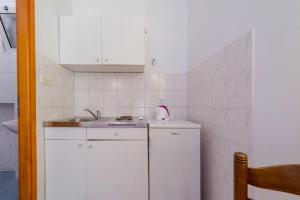 a small kitchen with a sink and a refrigerator at Apartments Dia in Dubrovnik