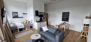 uma sala de estar com um sofá e uma cama em Charleroi Cozy Home em Charleroi