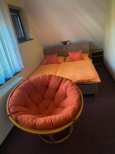 een slaapkamer met een bed met een rode stoel bij Penzion Z&Z in Tábor