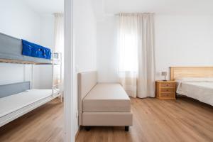 A bed or beds in a room at Olbia Rooms