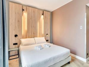 a bedroom with a white bed and wooden walls at B&B Hotel Milano Aosta in Milan