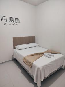 A bed or beds in a room at M&M flat 03, próximo ao centro, UFT