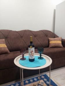 a bottle of wine on a table with two glasses at Kitesa's cozy apartment in Mtskheta