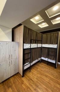 a room with three bunk beds and a wooden floor at Like Hostel in Chişinău