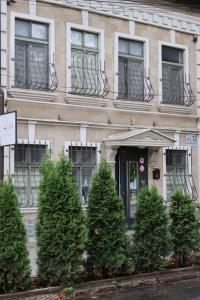 a building with christmas trees in front of it at Like Hostel in Chişinău