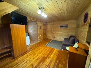 a living room with a couch and wooden floors at Arnika in Skhidnitsa