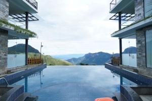 una piscina con montagne sullo sfondo di Chandys Drizzle Drops - Munnar Top Station a Munnar