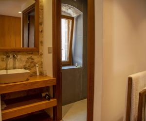 a bathroom with a sink and a mirror at Zoe Hora in Dhërmi