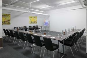 a large conference room with a long table and chairs at Radisson Blu Hotel, Kyiv Podil City Centre in Kyiv