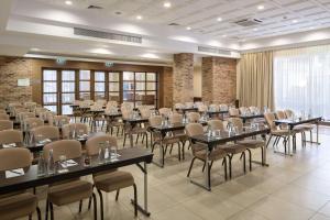 a large banquet hall with tables and chairs at Radisson Blu Hotel, Kyiv Podil City Centre in Kyiv