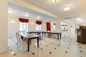 a large dining room with long tables and chairs at Royal Hotel Modlin in Nowy Dwór Mazowiecki