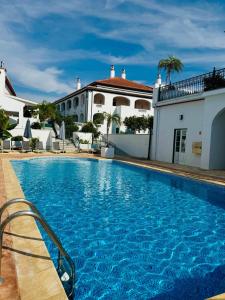 a large swimming pool in front of a building at SOLAR DOS FRADES in Ferreira do Alentejo