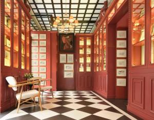 a dining room with red walls and a checkered floor at Only YOU Boutique Hotel Madrid in Madrid