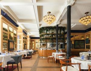 a restaurant with white tables and chairs and a bar at Only YOU Boutique Hotel Madrid in Madrid