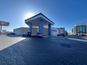 a parking lot with cars parked in front of a building at Studio 6 Suites Amarillo, TX West Medical Center in Amarillo