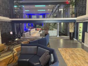 a lobby with a couch and chairs in a building at Studio 6 Suites Amarillo, TX West Medical Center in Amarillo