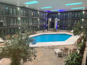 a large building with a pool in the middle of it at Studio 6 Suites Amarillo, TX West Medical Center in Amarillo