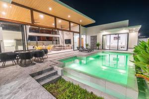 an indoor swimming pool in a house with a patio at Villa Chang - Fisherman Village Bophut in Bophut 