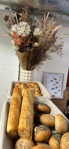 a tray of bread and a vase with a bunch of flowers at Hotel Karlova Prague in Prague