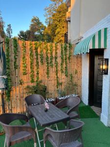 a patio with a table and chairs and a fence at Ortus - Murree Hills in Murree