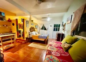 a woman sitting in a chair in a living room at Casa Cereza Apartments in Puerto Vallarta