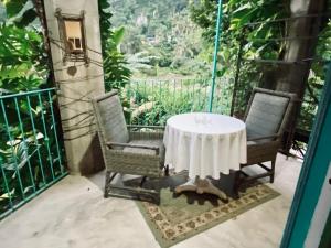 a table and two chairs on a balcony at Casa Cereza Apartments in Puerto Vallarta