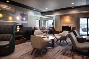 a lobby with chairs and a table and a fireplace at Courtyard Novato Marin/Sonoma in Novato