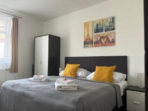 a bedroom with a large bed with towels on it at Hotel Pangea in Telč